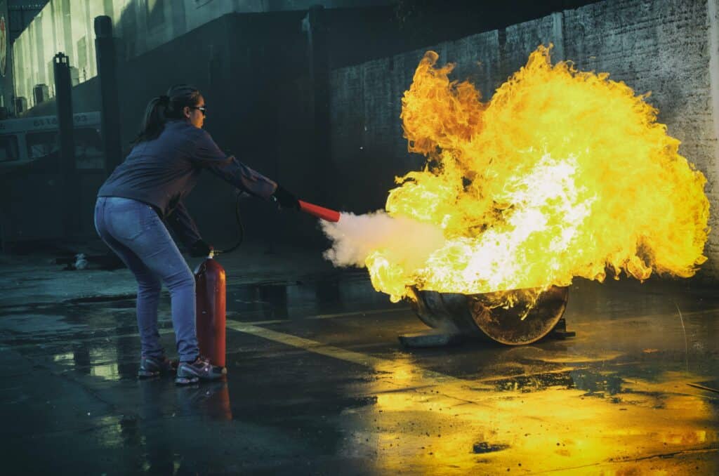 A Lady is trying to extinguish the fire