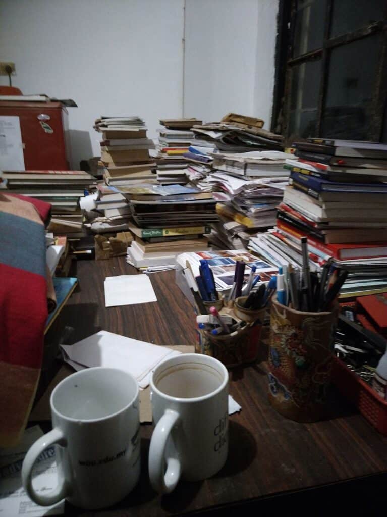 Cluttered writer's table (Source: Wikimedia Commons)