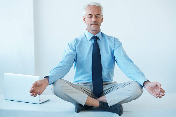 A man sitting in a cross-legged position