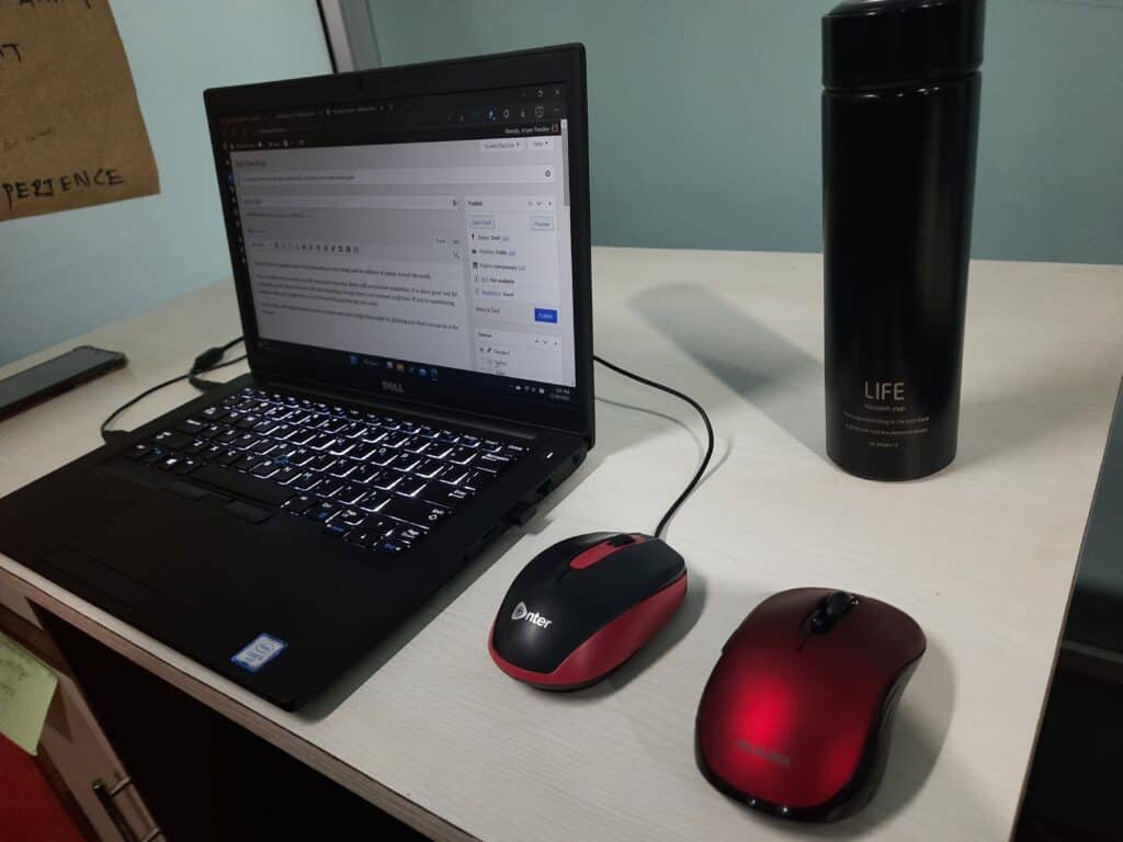 a wired mouse connected to laptop and the wireless mouse on the table